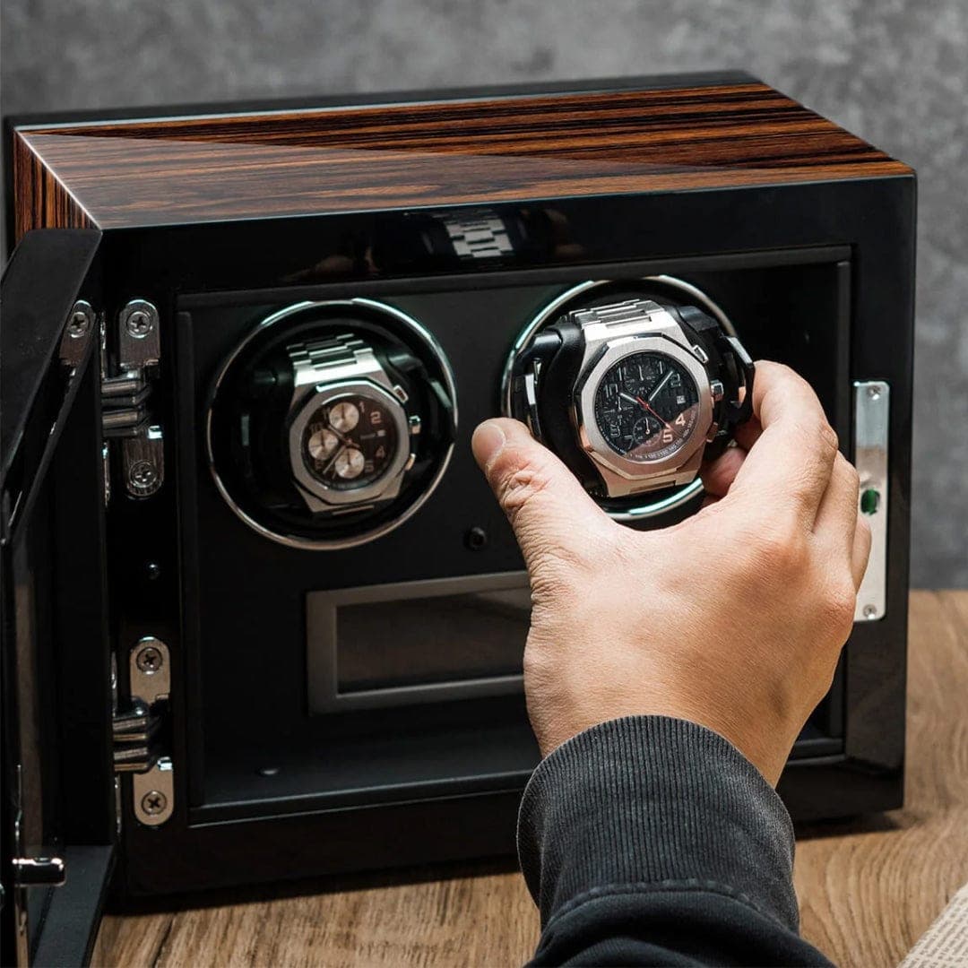 A watch being placed into a winder