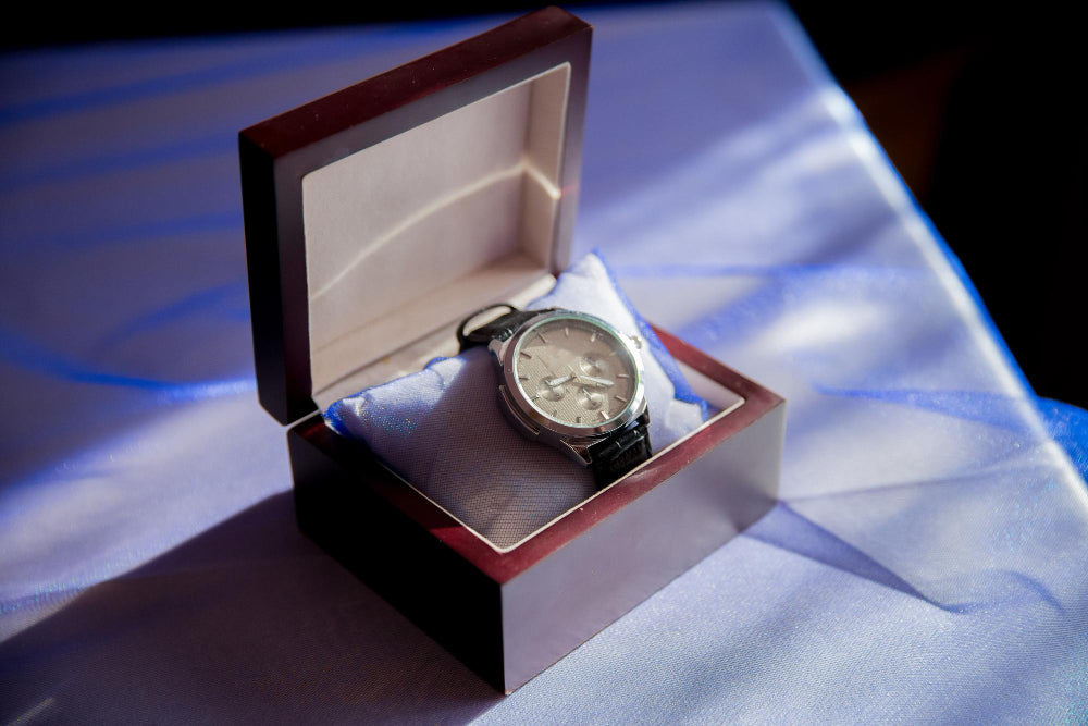 Luxury leather watch case for men in rich brown with fine stitching and a metal clasp, designed for elegant storage and timeless style.