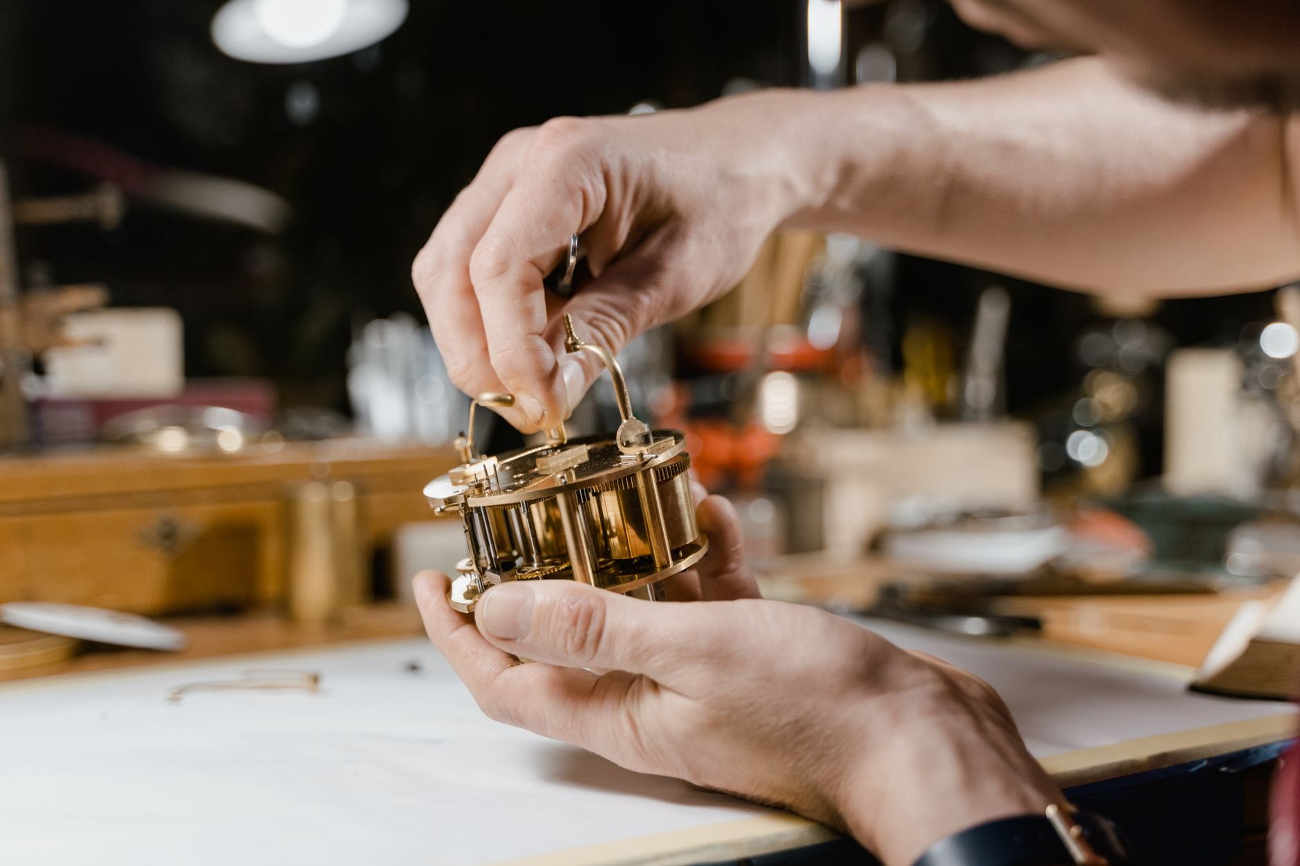 Craftsman meticulously assembling intricate clockwork components with precision tools.