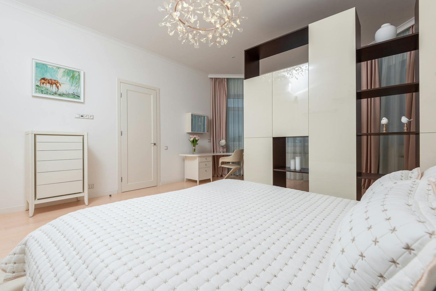 Interior of empty bedroom with comfortable soft bed and light furniture in apartment