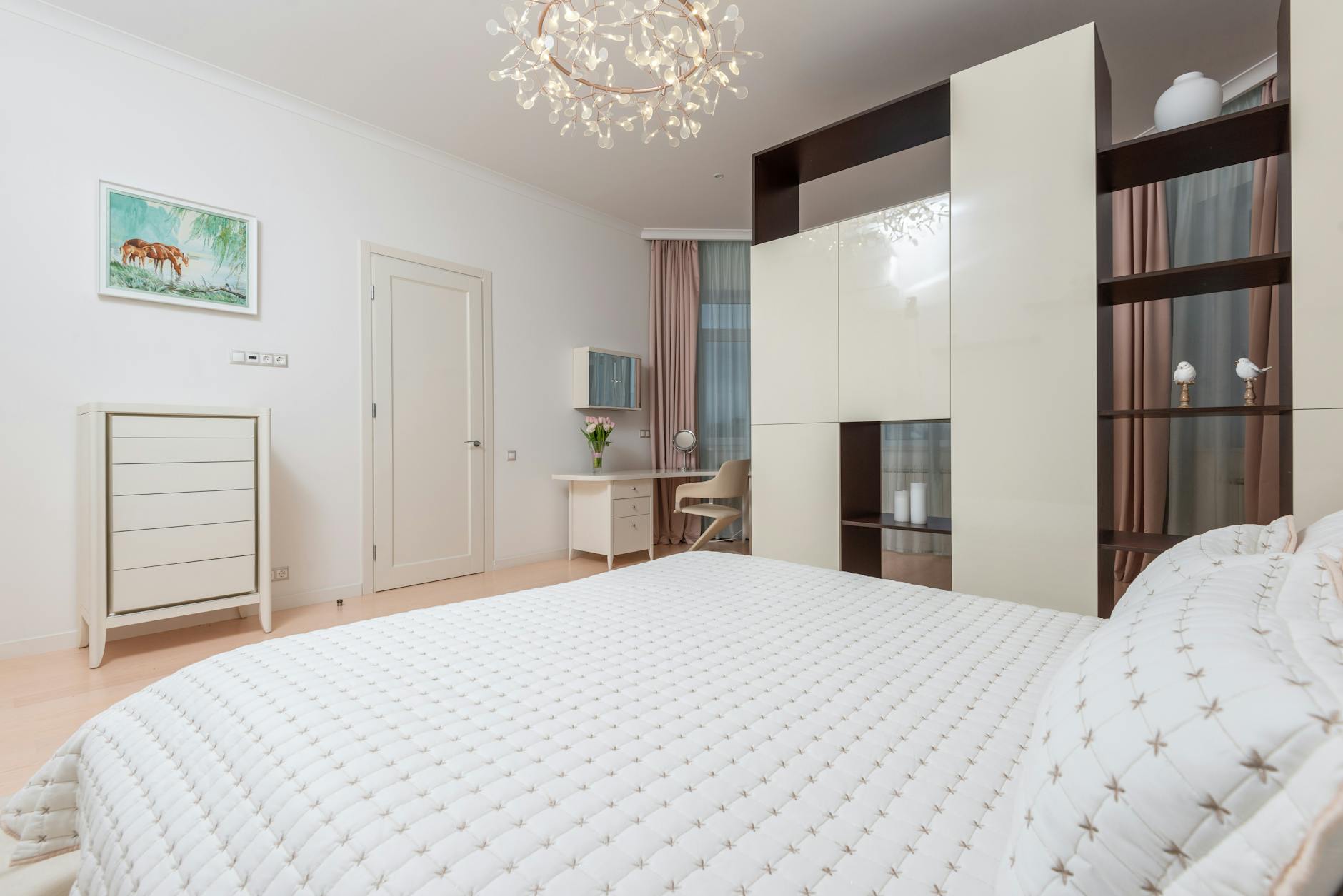 Interior of empty bedroom with comfortable soft bed and light furniture in apartment